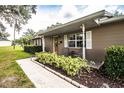 Cozy front porch with chairs and a beautifully landscaped yard and flower bed at 6920 Newman E Cir, Lakeland, FL 33811