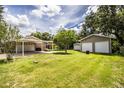 Image of a detached two-car garage and carport in the backyard of the home at 6920 Newman E Cir, Lakeland, FL 33811