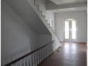 Bright entryway featuring staircase, double doors, and hardwood flooring at 701 1St Ne St, Fort Meade, FL 33841