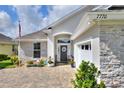 Inviting home exterior featuring stone accents, manicured landscaping, and a brick-paved walkway leading to the front entrance at 7770 Lake James Blvd, Lakeland, FL 33810