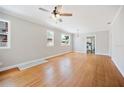 Sunlit living room with gleaming hardwood floors, neutral paint, and large windows at 783 E Central Ave, Eagle Lake, FL 33839