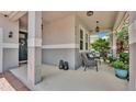 Covered front porch featuring a seating area with comfortable chairs and stylish outdoor decor at 8120 Soldierwood St, Winter Garden, FL 34787