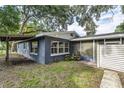 A back view of a single Gathering residence with a covered walkway and large sliding glass doors to the lanai at 906 E Lowell St, Lakeland, FL 33805