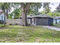 Landscaped front yard and charming exterior create a welcoming entrance to this single Gathering residence at 906 E Lowell St, Lakeland, FL 33805
