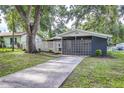 Single Gathering home featuring a well-kept yard, concrete driveway, and an inviting covered front entry at 906 E Lowell St, Lakeland, FL 33805