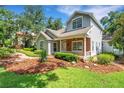 Inviting home featuring a brick-accented porch, manicured lawn, and charming curb appeal at 1018 E Highland Dr, Lakeland, FL 33813