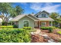 Charming home with brick accents, a well-manicured lawn, and lush landscaping for added curb appeal at 1018 E Highland Dr, Lakeland, FL 33813