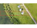 Aerial view of property, featuring vast lawn space, pond access and large home on the property at 1044 Timbers Dr, Fort Meade, FL 33841
