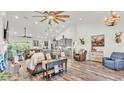 Spacious living room with high ceilings, wood floors, ample seating, and an open floor plan into the kitchen at 1044 Timbers Dr, Fort Meade, FL 33841