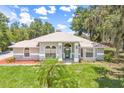 Picture of a charming home with a well-manicured lawn and mature trees at 1102 Berkley Ln, Winter Haven, FL 33880