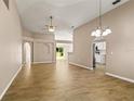 Spacious living room boasting tile floors, neutral walls, decorative lighting, and arched doorways at 1125 Blackjack Ridge St, Minneola, FL 34715