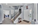 Spacious foyer featuring a staircase and tile flooring at 141 Minniehaha Cir, Haines City, FL 33844