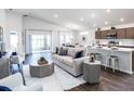 Open-concept living room and kitchen with stylish furnishings and natural light at 1537 Otter Woods Ln, Auburndale, FL 33823