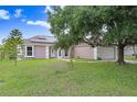 Inviting single-story home with a manicured lawn and a charming walkway at 169 Birmingham Dr, Kissimmee, FL 34758