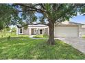 Lovely single-story home with a well-maintained lawn and mature trees at 169 Birmingham Dr, Kissimmee, FL 34758