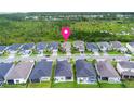 Aerial view of homes in a well-planned neighborhood with lush green spaces, marked with a location pin at 180 Azure Mist Way, Daytona Beach, FL 32124