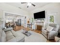 Open living area with a cozy fireplace, hardwood floors, and seamless flow to the dining and kitchen at 213 Cannon St, Lakeland, FL 33803
