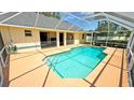 Relaxing in-ground pool with a screened enclosure, spacious patio, and private backyard, ready for enjoyment at 2264 Palmview E Cir, Auburndale, FL 33823