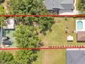 An overhead shot shows the backyard, pool, storage shed, and a glimpse of the neighboring homes at 2533 Peterson Rd, Lakeland, FL 33812