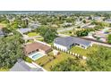 Aerial view of home with fenced yard, pool and shed in a neighborhood with mature trees and lawns at 2533 Peterson Rd, Lakeland, FL 33812
