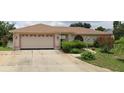 Single story home featuring a large driveway and attached garage at 341 Sterling Dr, Winter Haven, FL 33884