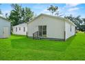 Exterior shot of a home with a large backyard and sliding glass door at 405 S 7Th Ave, Bartow, FL 33830