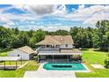 Spacious home features a large backyard, inground pool, carport, and ample green space surrounded by mature trees at 4510 Cindy Rd, Lakeland, FL 33810
