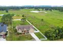 Aerial view of a single-Gathering home surrounded by a white fence and a large green lawn at 5370 Knights Station Rd, Lakeland, FL 33810