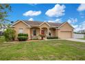 Charming single Gathering home with a well-manicured lawn and inviting front porch at 5370 Knights Station Rd, Lakeland, FL 33810