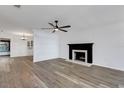 Bright living room featuring a fireplace, fan, and contemporary wood-look flooring at 5722 Antler Trl, Lakeland, FL 33811