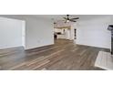 Open-concept living area with wood-look floors, adjacent to the kitchen and dining nook at 5722 Antler Trl, Lakeland, FL 33811