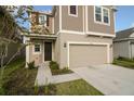 Well-kept two-story home with a two-car garage, complemented by green grass and landscaping at 6524 Great Bear Drive Blvd, Lakeland, FL 33805