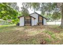 Spacious backyard featuring lush greenery and mature trees, offering a serene outdoor space at 910 Van Dr, Auburndale, FL 33823