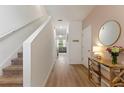 Inviting foyer with light wood floors and staircase leading to the upper level at 943 Grandin St, Davenport, FL 33837