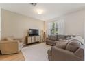 Comfortable living room with neutral tones, plush seating, and natural light at 943 Grandin St, Davenport, FL 33837