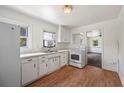 Bright kitchen featuring white appliances, ample cabinet space, and wood flooring at 1133 Bryn Mawr Ave, Lake Wales, FL 33853