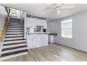 Kitchen with light grey cabinets, a breakfast bar and stair access to the 2nd floor at 121 F Sw Ave, Winter Haven, FL 33880