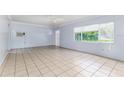 Bright living room with tiled floors, and large window providing ample light at 121 F Sw Ave, Winter Haven, FL 33880