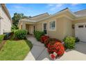 Inviting home exterior with well-manicured lawn, mature shrubs, and a charming walkway to the front door at 1707 Laurel Glen Pl, Lakeland, FL 33803