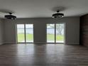 Spacious living room with wood-look floors and sliding glass doors with lake views at 21 Lake Ave, Winter Haven, FL 33880