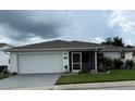 Inviting single-story home with a two-car garage, screened-in porch, and well-maintained landscaping at 2235 Grand Cypress Dr # 561, Lakeland, FL 33810
