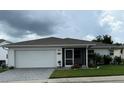 Inviting single-story home with a two-car garage, screened-in porch, and well-maintained landscaping at 2235 Grand Cypress Dr # 561, Lakeland, FL 33810