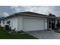 Well-maintained home featuring a spacious two-car garage, landscaped yard, and convenient screen porch at 2235 Grand Cypress Dr # 561, Lakeland, FL 33810