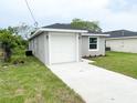 Gray single-story home with a white garage door and well-kept lawn and landscaping at 2517 Sunset Dr, Winter Haven, FL 33881
