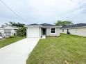 Well-maintained home with a one-car garage, green front door, and a lush lawn at 2517 Sunset Dr, Winter Haven, FL 33881