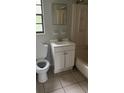Well-lit bathroom with a single sink vanity and a shower-tub combo at 2708 Dixie Rd, Lakeland, FL 33801