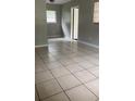 Spacious living room featuring neutral walls, tiled floor, and natural light from windows at 2708 Dixie Rd, Lakeland, FL 33801