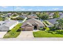 An aerial shot of the home featuring a well-manicured lawn, two car garage, and lovely neighborhood at 2812 Whitney St, Lakeland, FL 33813