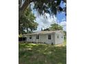 Inviting one-story home featuring a well-manicured lawn and lush landscaping at 29 Coleman Rd, Winter Haven, FL 33880