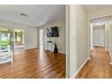 Living room features hardwood floors and sliding doors for natural light at 3560 Sandpiper Ln, Mulberry, FL 33860